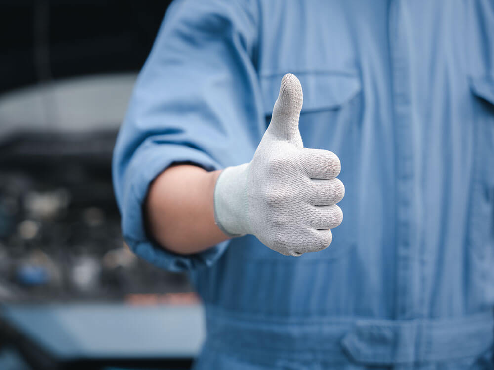 Thumbs up by mechanic in gloves